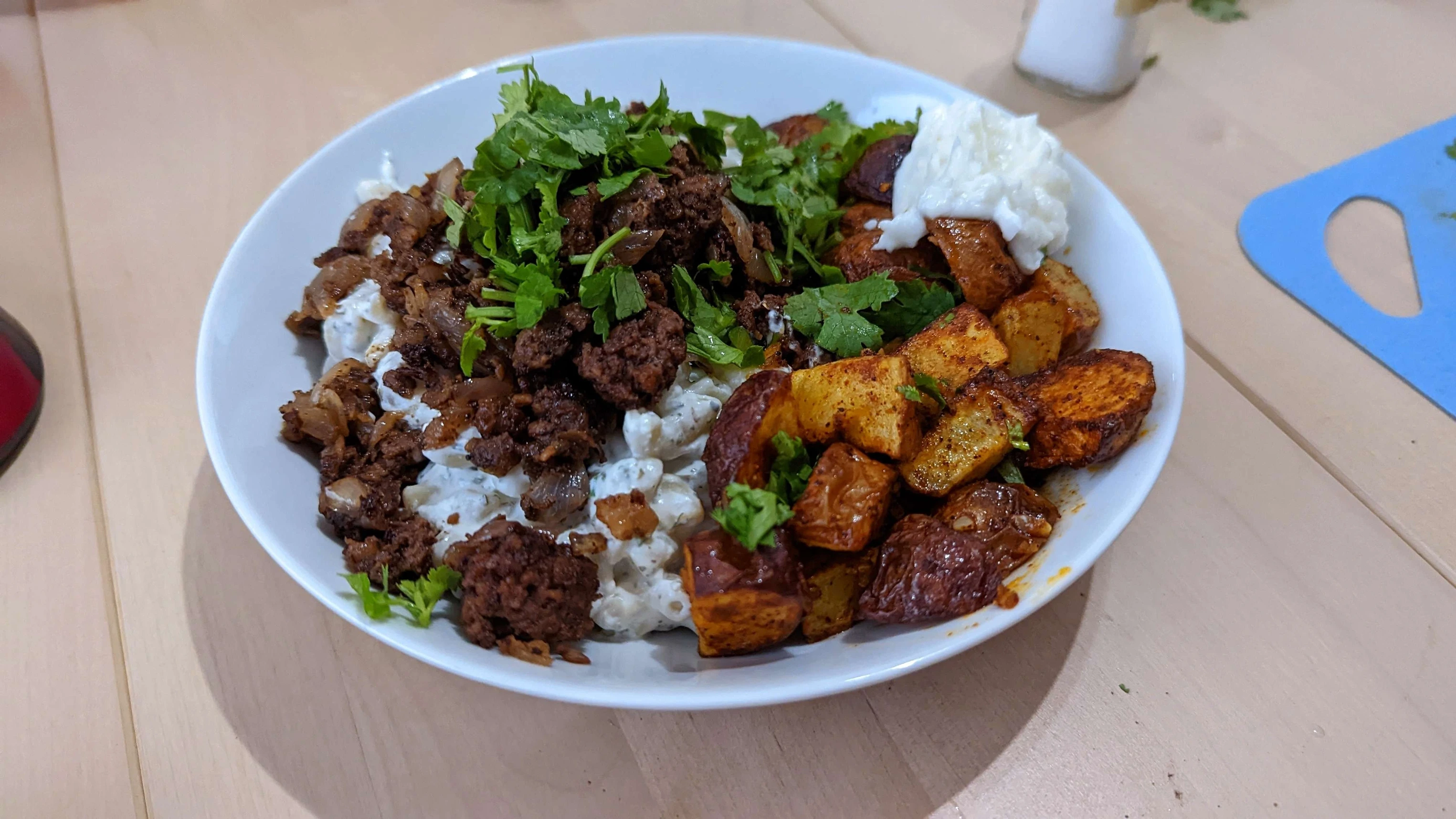 Macaroni bel laban with batata harra (spicy potatoes) and toum. I used Impossible Burger in place of the usual ground beef.