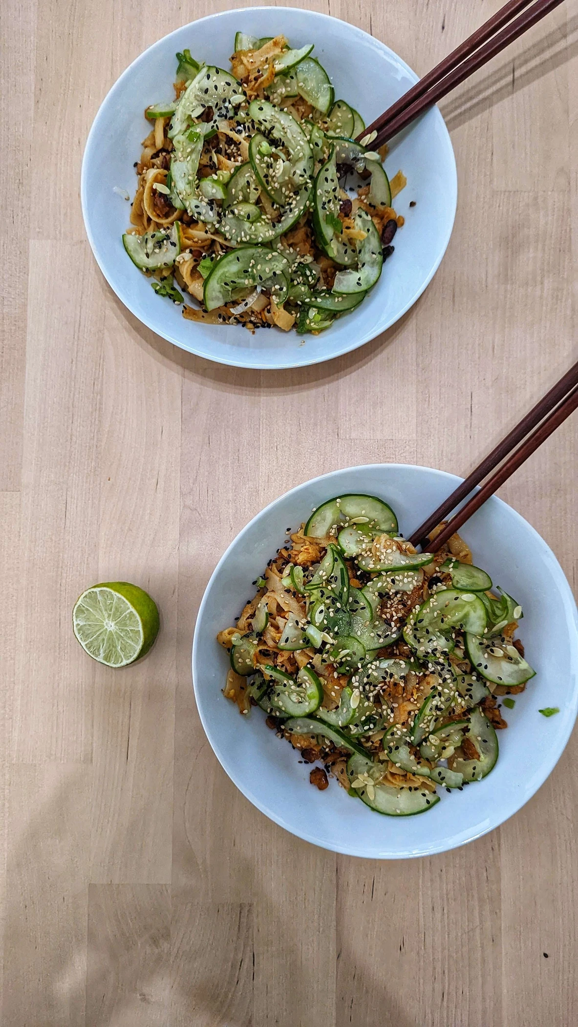 A noodle dish with peanut butter sauce, fried tempeh, and cucumber pickles for garnish. Recipe was from <a href=https://www.bonappetit.com/recipe/peanutty-noodles-with-tempeh-crumbles>here</a>.