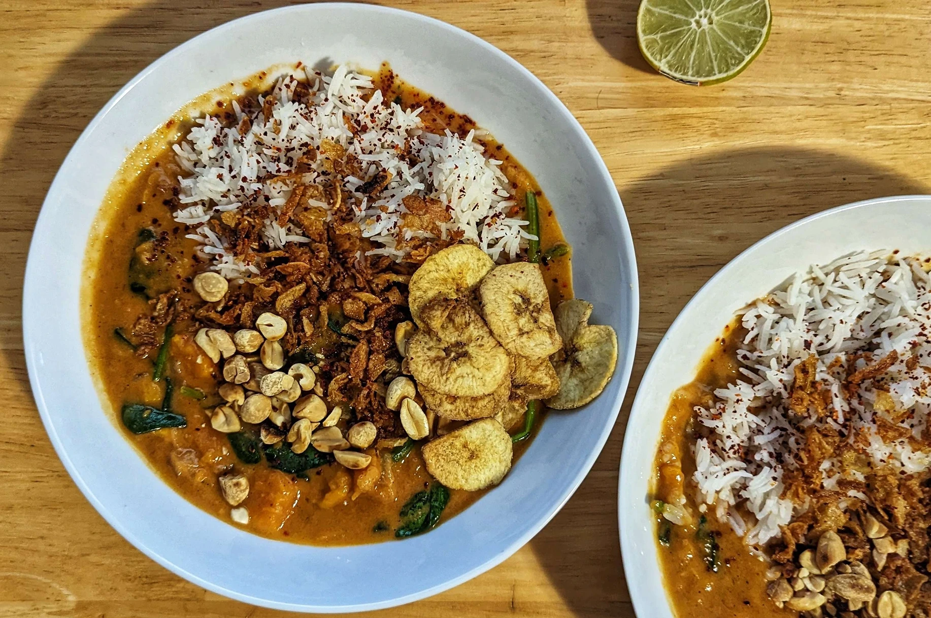 Peanut stew from Zoe Alakija's 'Afro Vegan' book, topped with plantain chips, peanuts, and Suraj crispy onions.